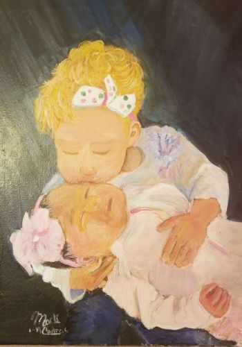 Girl holding baby painting